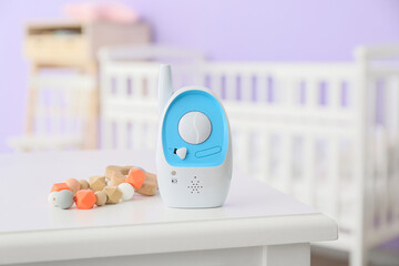Fototapeta na wymiar Modern baby monitor and teether on table in room