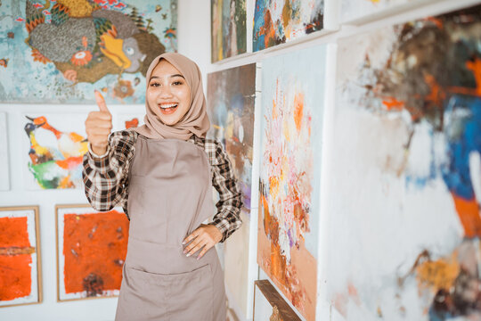 Muslim Asian Female Artist Showing Thumb Up