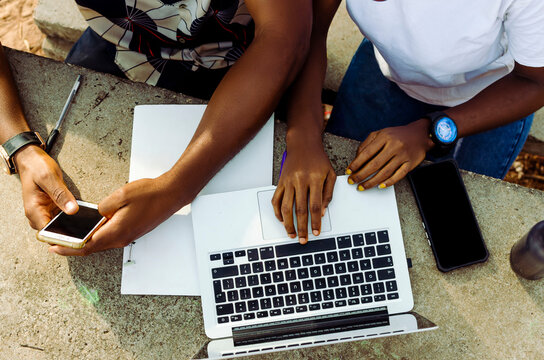 hands of young freelancer working with smartphone and laptop