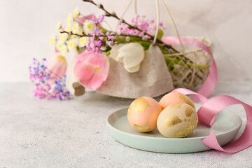 Fototapeta na wymiar Plate with Easter eggs on light background