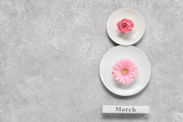Obraz na płótnie Canvas Creative composition with plates, flowers and word MARCH on light background. International Women's Day celebration