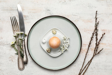 Stylish Easter table setting on light background