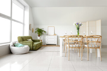 Interior of light room with table served for International Women's Day celebration