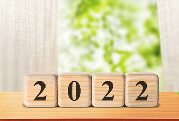 Flipping wooden cubes blocks placed on table. New year and holiday concept.