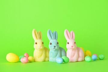 Cute Easter bunnies and eggs on green background