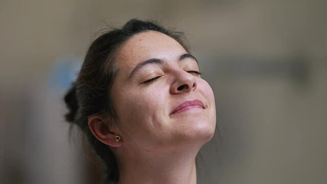 Person looking at sky closing eyes satisfied woman eyes closed in meditation