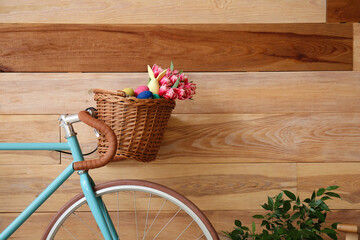 Bicycle with Easter basket on wooden background