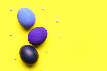 Blue Easter eggs on yellow background