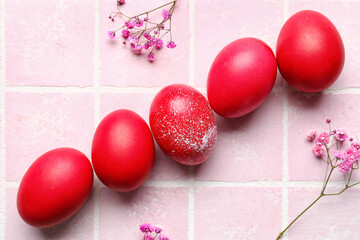 Beautiful Easter eggs and flowers on color tile