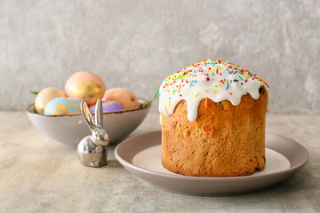 Plate with delicious Easter cake on grey background