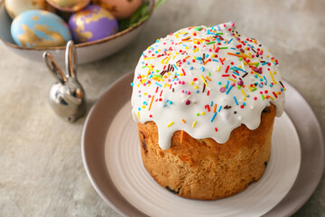 Plate with delicious Easter cake on grey background