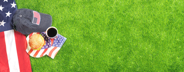 Burger and drinks on green grass. Outdoor. USA flag. National holidays.