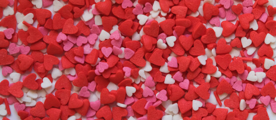 sprinkle hearts on a white background with a place for text