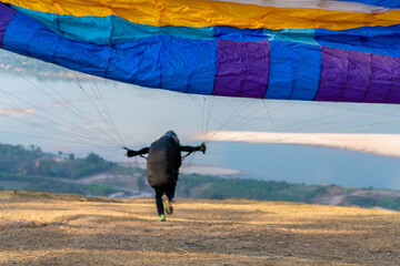 Starting point paraglider flying on mountains in summer day