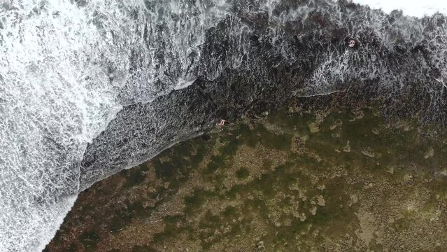 Vertical aerial view of Indian ocean waves and coast in Sri Lanka