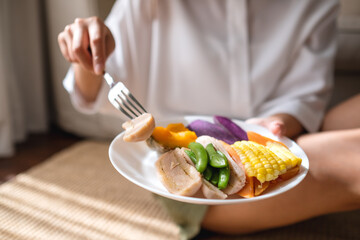Closeup image of a woman eating vegetables, Vegan, Clean food, dieting concept