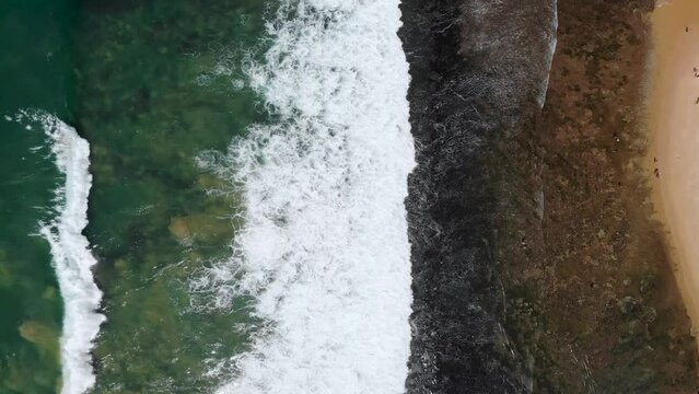 Vertical aerial view of Indian ocean waves and coast in Sri Lanka