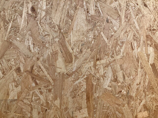 The surface of Oriented strand board or engineered wood used in construction. Mixed wood strands or flakes
