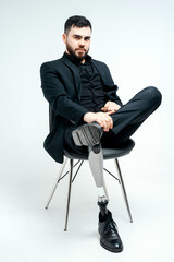 Disabled young man with prosthetic leg, artificial limb concept on white background