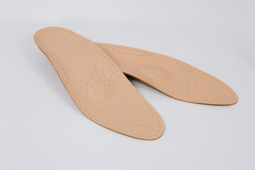 Isolated orthopedic insoles on a white background. Medical insoles. Foot care. Insole cutaway layers. Treatment and prevention of flat feet and foot diseases. Inner soles of shoes.