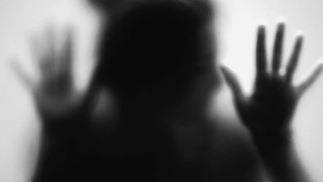 Spooky person behind glass scary person stuck in anxiety and depression concept monochrome