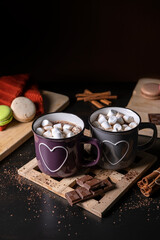 Obraz na płótnie Canvas Two Cups of Fresh Cocoa with Marshmallows by the Dark Background. Vertical View 