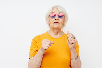 smiling elderly woman in fashionable glasses hand gestures close-up emotions