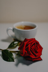 a cup of tea with a rose