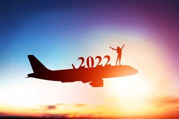 Happy New Year 2022 concept. Numbers sitting on planes for travel.
