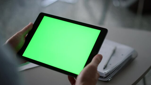 Entrepreneur hands holding tablet looking screen chroma key in workplace cafe.