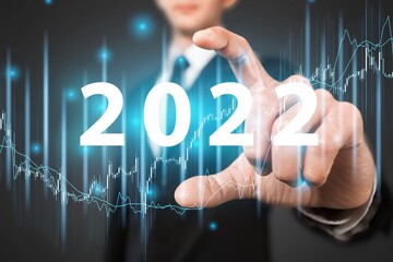 Businessman in suit analysis plan profit chart. economic forecasts for 2022.