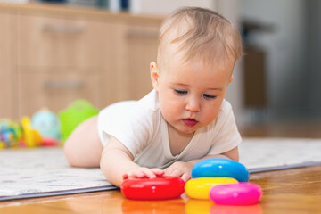 Cute little boy playing with toys at home