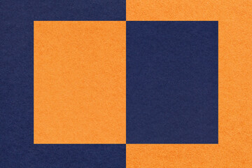Texture of navy blue and orange paper background with geometric shape and pattern, macro.