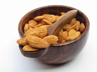 Almonds  in a wooden bowl with spoon 