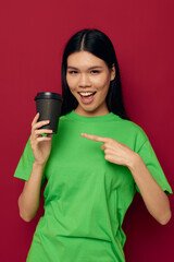 Fototapeta premium Charming young Asian woman posing in a green t-shirt disposable black glasses studio model unaltered