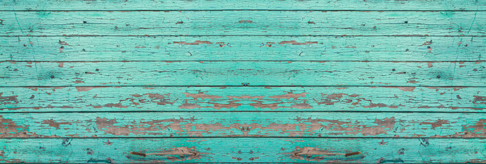 The texture of old wood boards. Wooden surface with cracks of turquoise paint. wooden panoramic background.