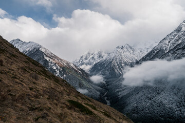 Fototapeta na wymiar The Caucasus mountains in Russia. Beautiful landscape. Nature and cloudy mountain background.