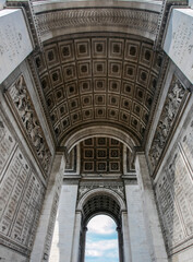 View from below of the internal arches of the Arc de Triomphe in Paris. - obrazy, fototapety, plakaty