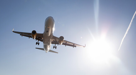 Airplane preparing the landing with a blue sky