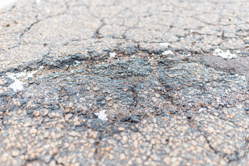 Damaged road. Deep crack on the asphalt. Closeup.view from above.