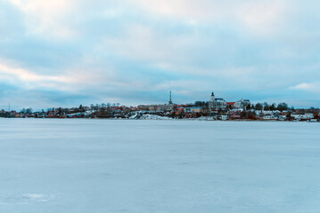 Telsiai town and lake in Lithuania Nice view winter of houses on coast of frozen Lake.Nice winter evening.