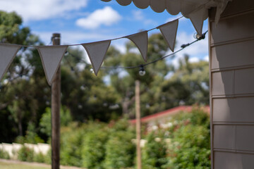 cute garland bunting of white flags outside on a house