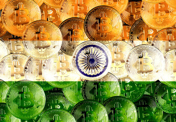 Holds the physical version of Bitcoin and the Indian flag. Conceptual image of cryptocurrency and blockchain technology in India. Double exposure creative bitcoin symbol hologram. 