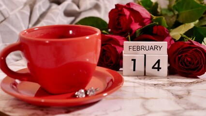 Background Festive Flatlay, composition for Valentine's Day on February 14. Coffee in a red cup, red rose flowers and diamond heart earrings at home in bed