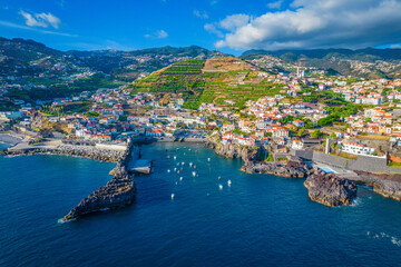 Aerial drone view of Camara de Lobos village panorama near to Funchal, Madeira. Small fisherman village with many small boats in a bay - obrazy, fototapety, plakaty