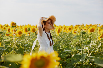 Fototapeta premium woman portrait In a field with blooming sunflowers unaltered