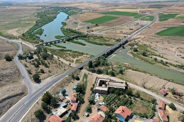 Kesikkopru Caravanserai was built in the 13th century during the Anatolian Seljuk period. A photograph of the caravanserai taken with a drone. The Kesik Bridge is located on the Kizilirmak River. 