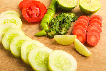 Helthy food concept : Raw vegetable slices on wooden board