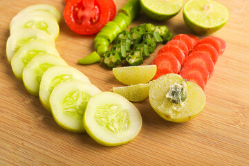 Helthy food concept : Raw vegetable slices on wooden board
