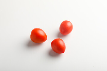 Fresh red tomato on white background.